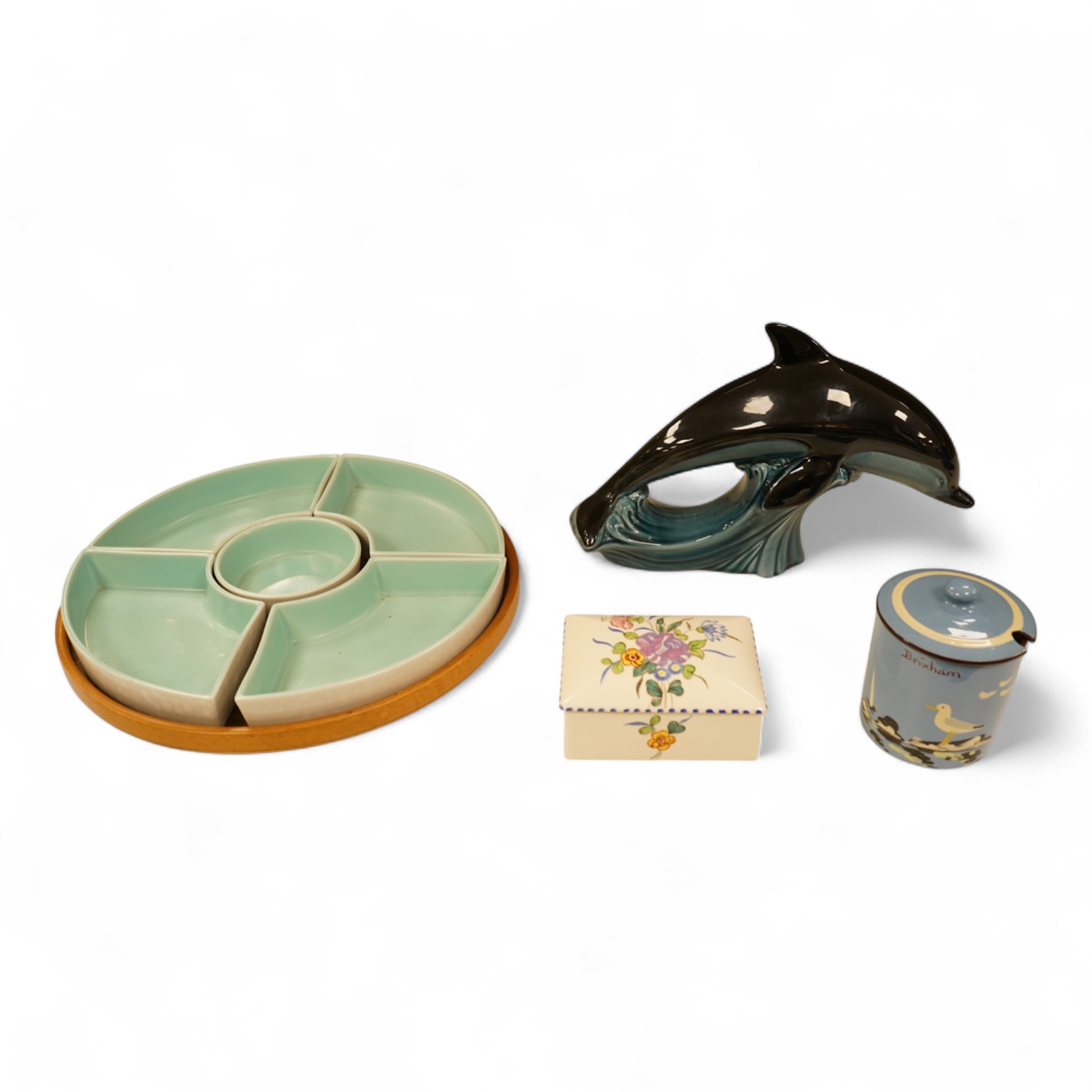 A Poole Pottery hors d’ouevres dish, a dolphin, a box and cover and a Torquay ware Brixham jar